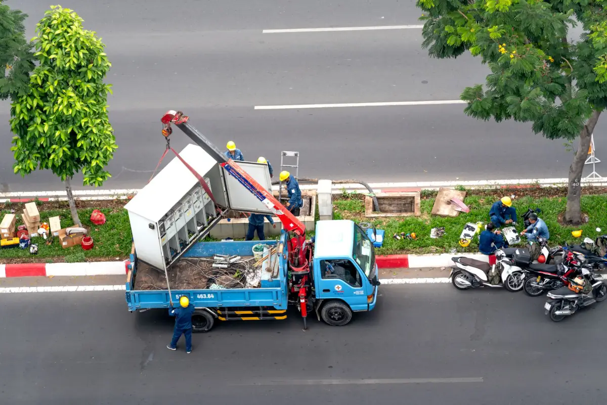 A crane truck set up on-site for a tree removal